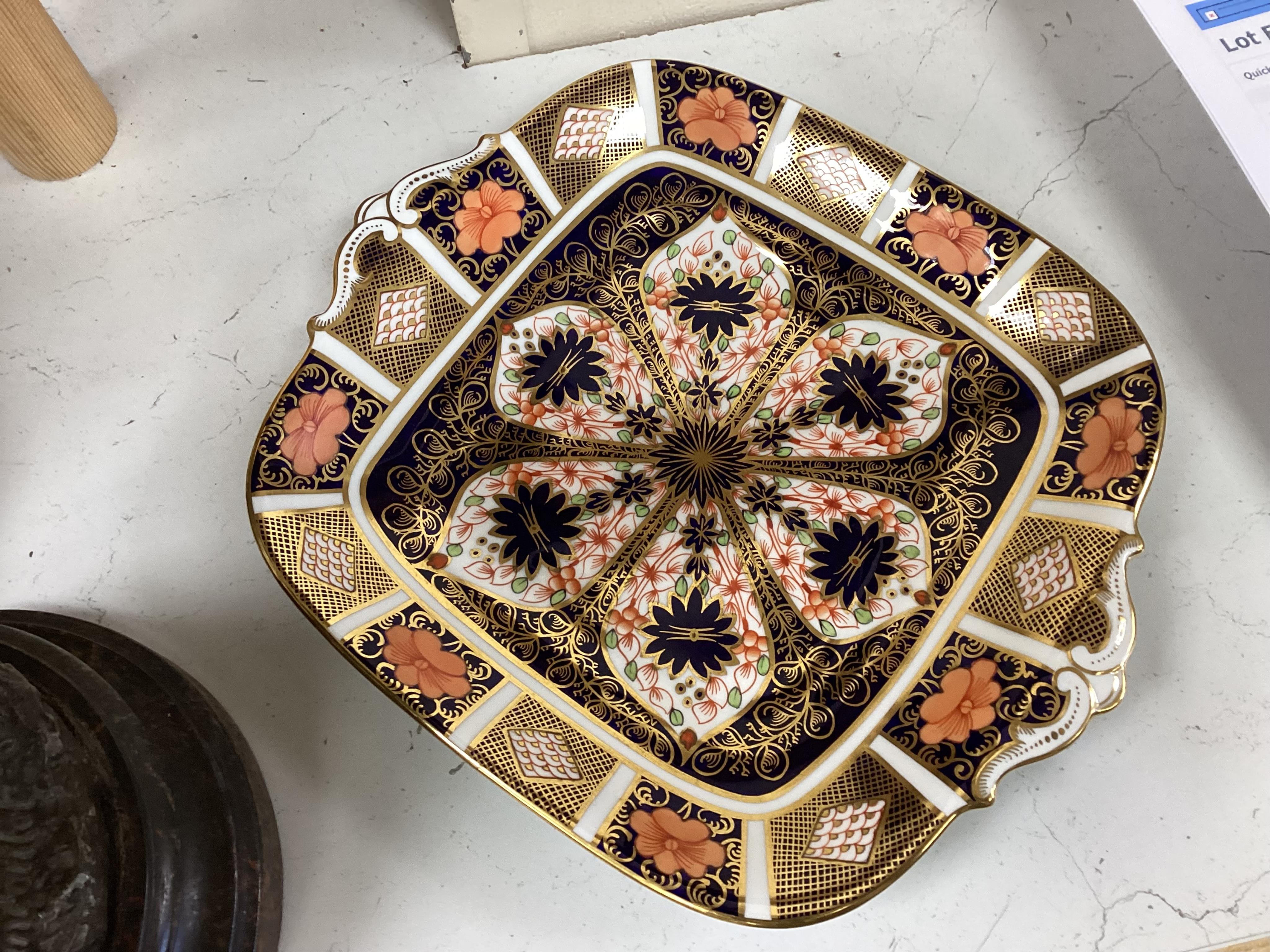 A quantity of Royal Crown Derby Imari to include a sandwich plate, cups and saucers and and miniature twin handled cups, largest 27cm in diameter
